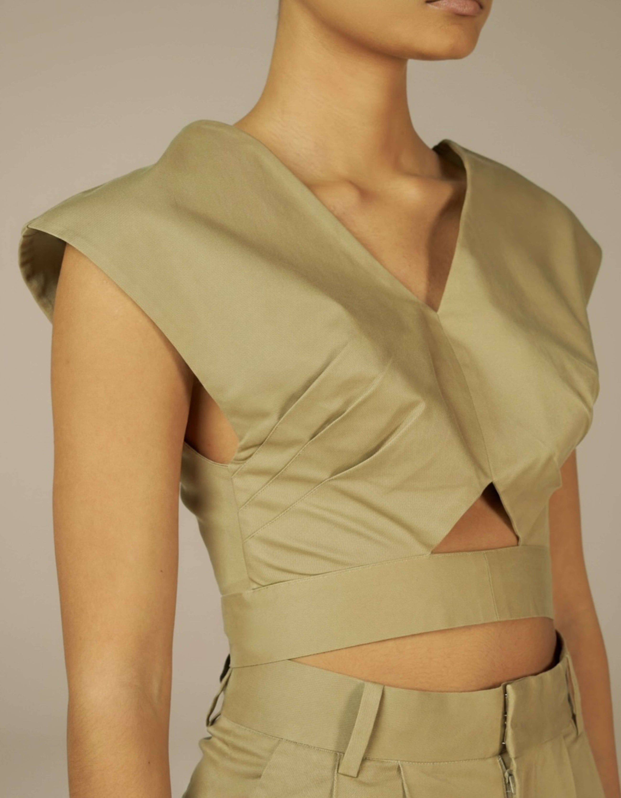 Sage structured crop top with V-neck cutout detail, minimalist luxury womenswear