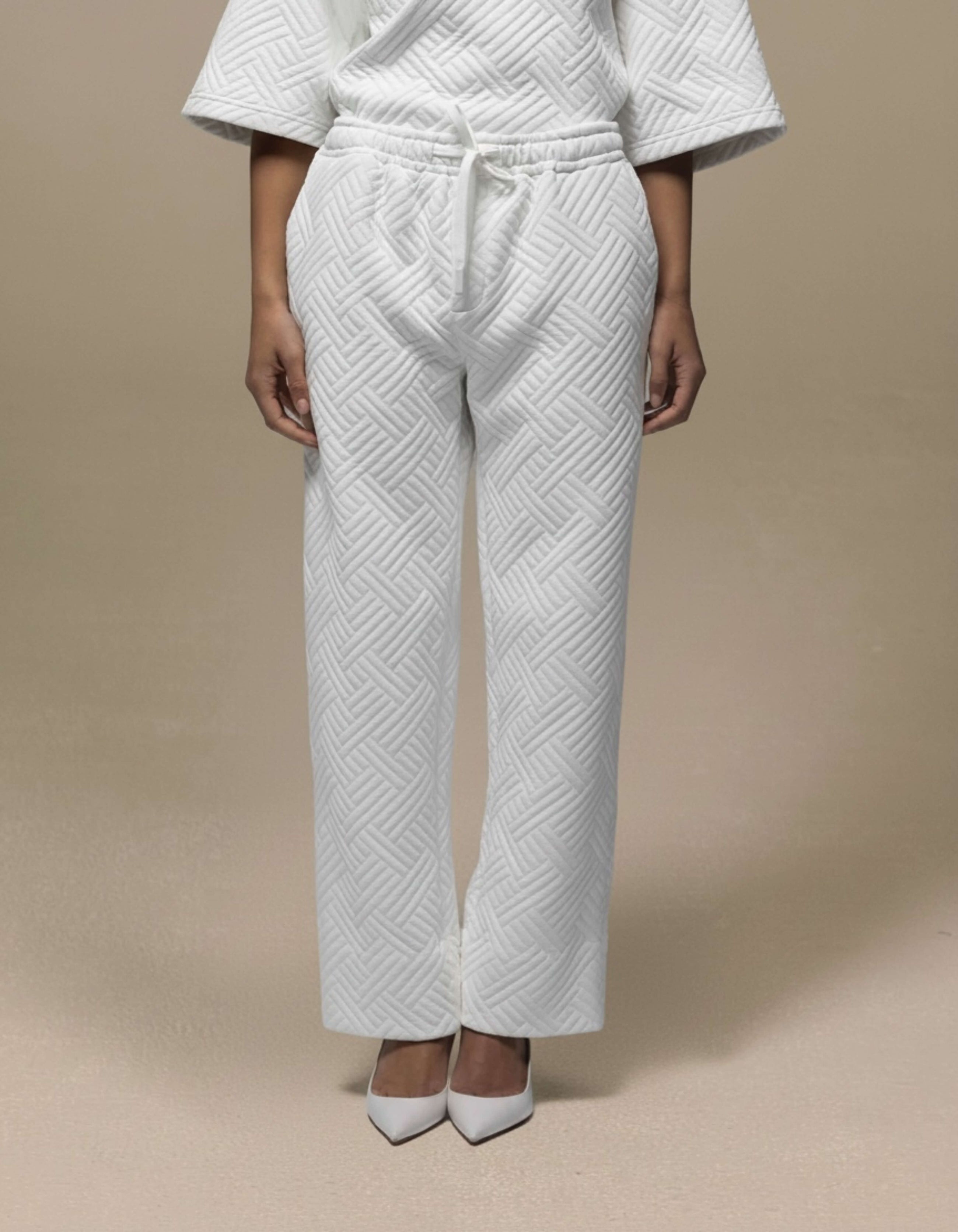 White quilted wide-leg trousers with drawstring waist, luxury womenswear