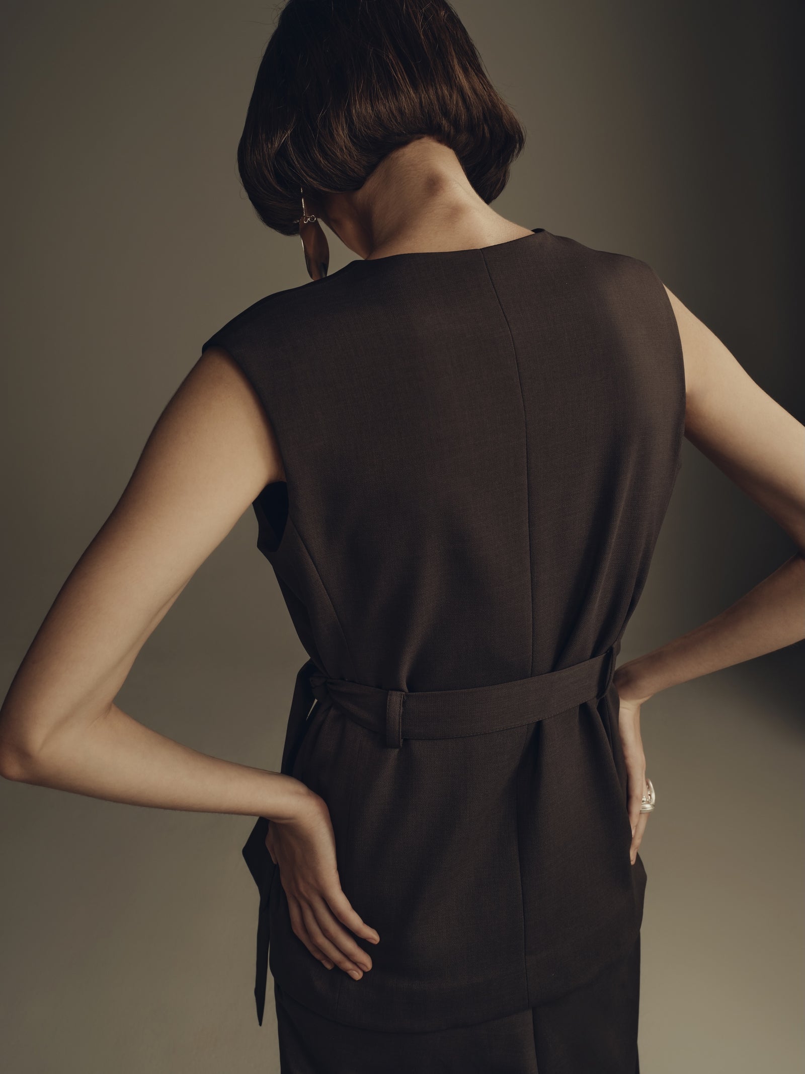 Sleeveless dark brown tailored minimalist dress with belted waist detail