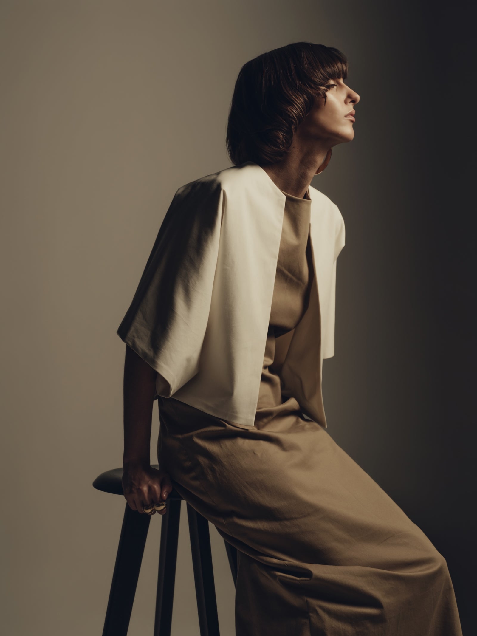 Minimalist luxury womenswear taupe maxi dress with ivory draped cape detail