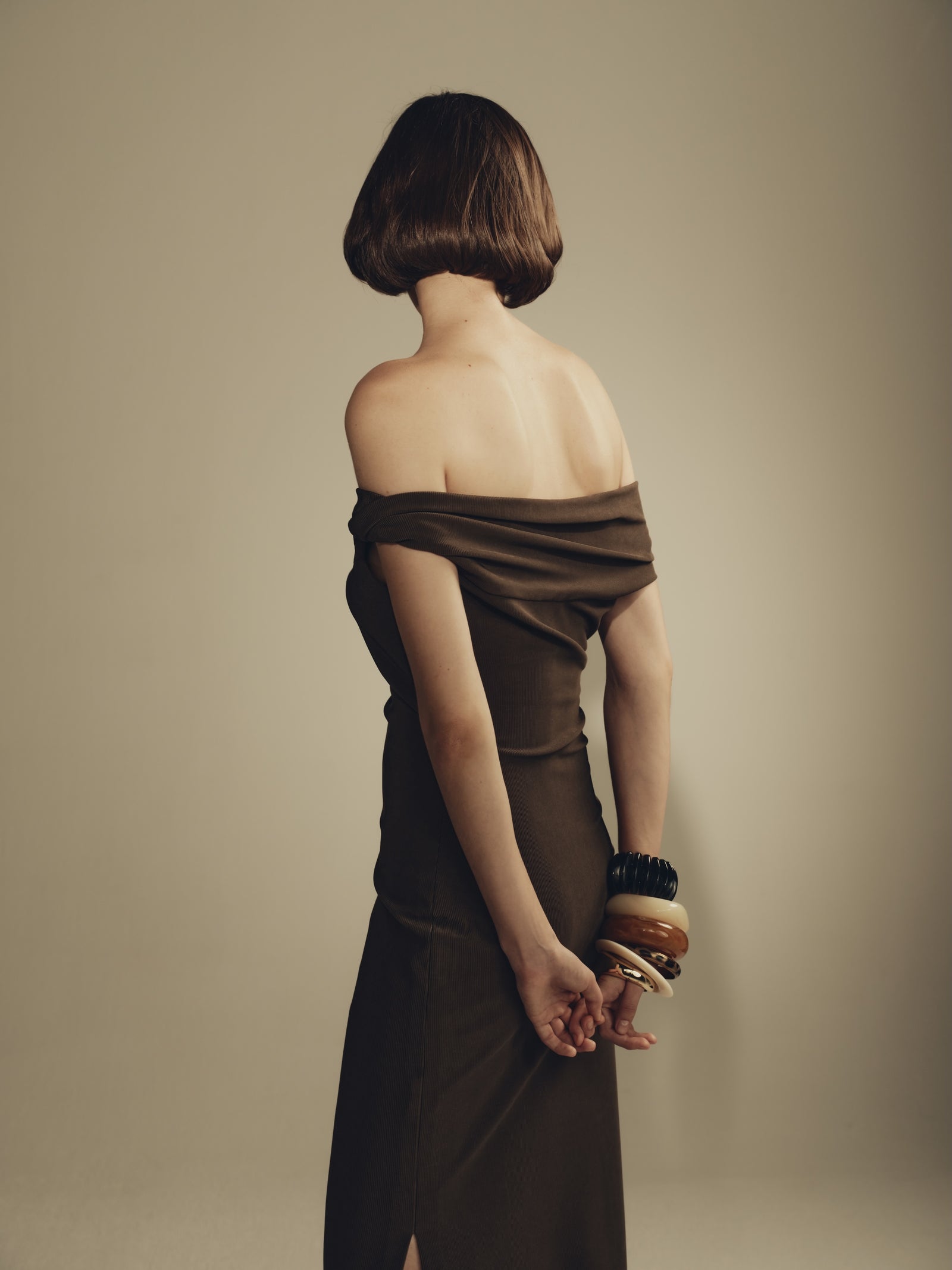 Draped off-shoulder olive maxi dress with stacked resin bangles bracelet styling