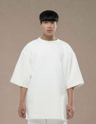 Oversized white quilted top with wide sleeves minimalist luxury womenswear
