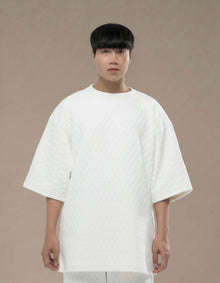 Oversized white quilted top with wide sleeves minimalist luxury womenswear

