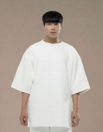 Oversized white quilted top with wide sleeves minimalist luxury womenswear
