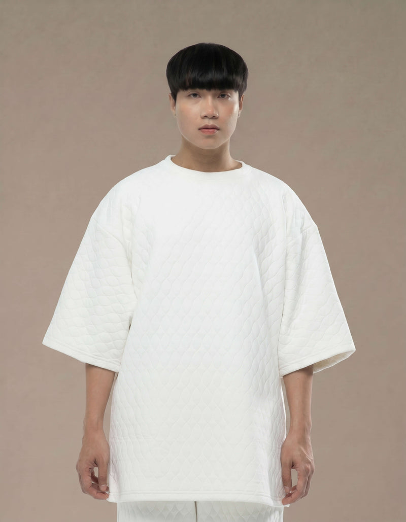 Oversized white quilted top with wide sleeves minimalist luxury womenswear
