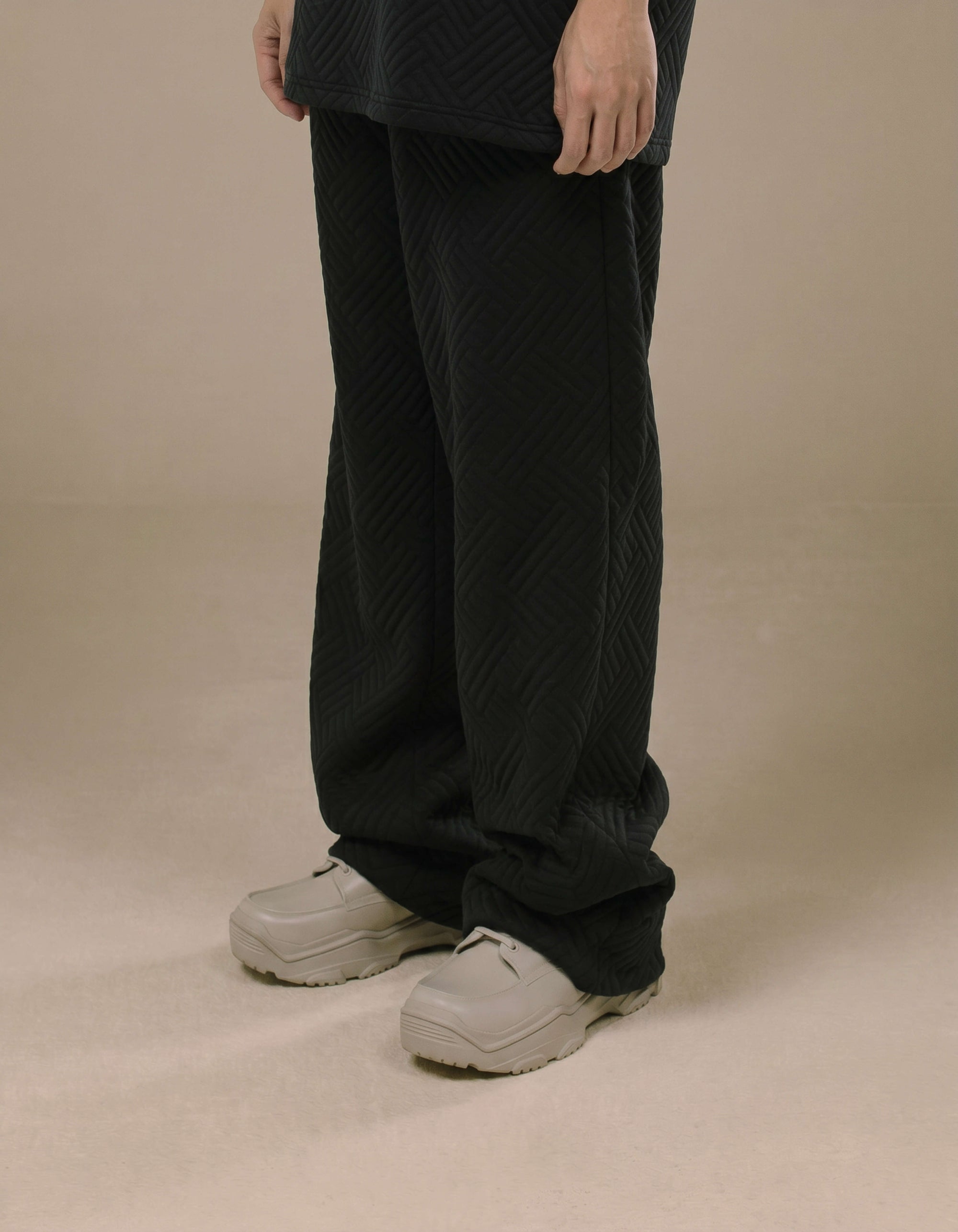 Black wide-leg quilted trousers with chevron texture, luxury womenswear
