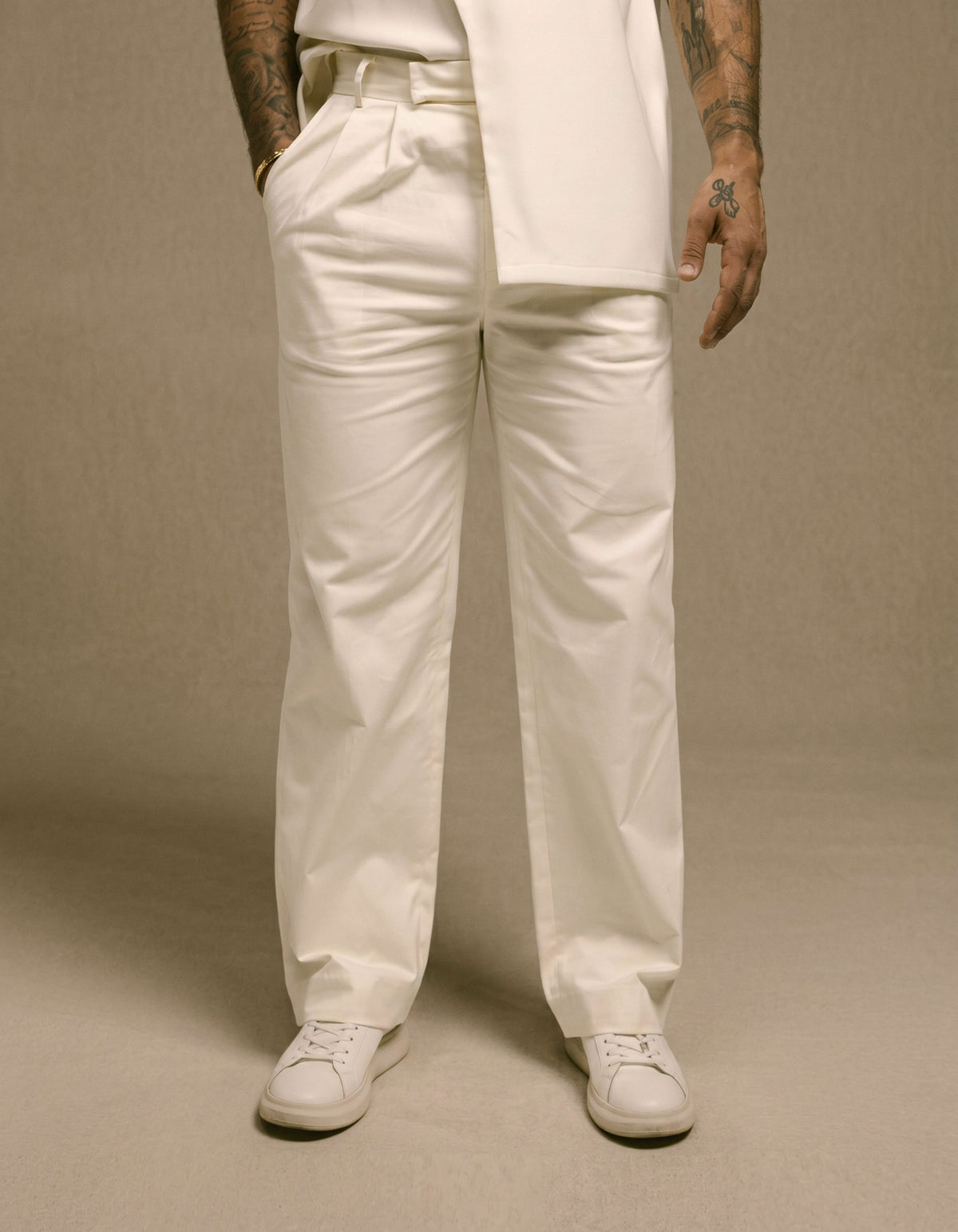 Ivory wide-leg tailored trousers styled with minimalist blazer
