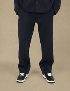 Navy quilted geometric jacquard straight-leg luxury trousers styled with sneakers

