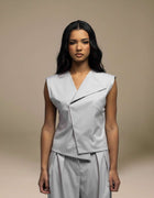 Sleeveless tailored grey top with angular wrap lapel detail, luxury womenswear
