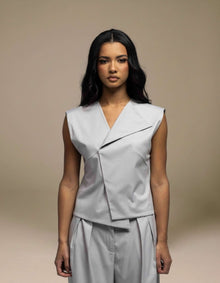 Sleeveless tailored grey top with angular wrap lapel detail, luxury womenswear
