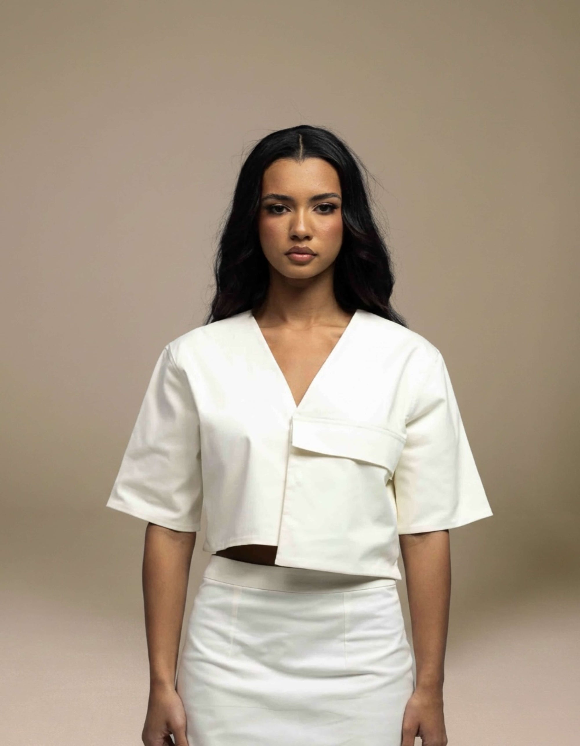 Ivory structured crop top with asymmetric hem and V-neckline, luxury womenswear
