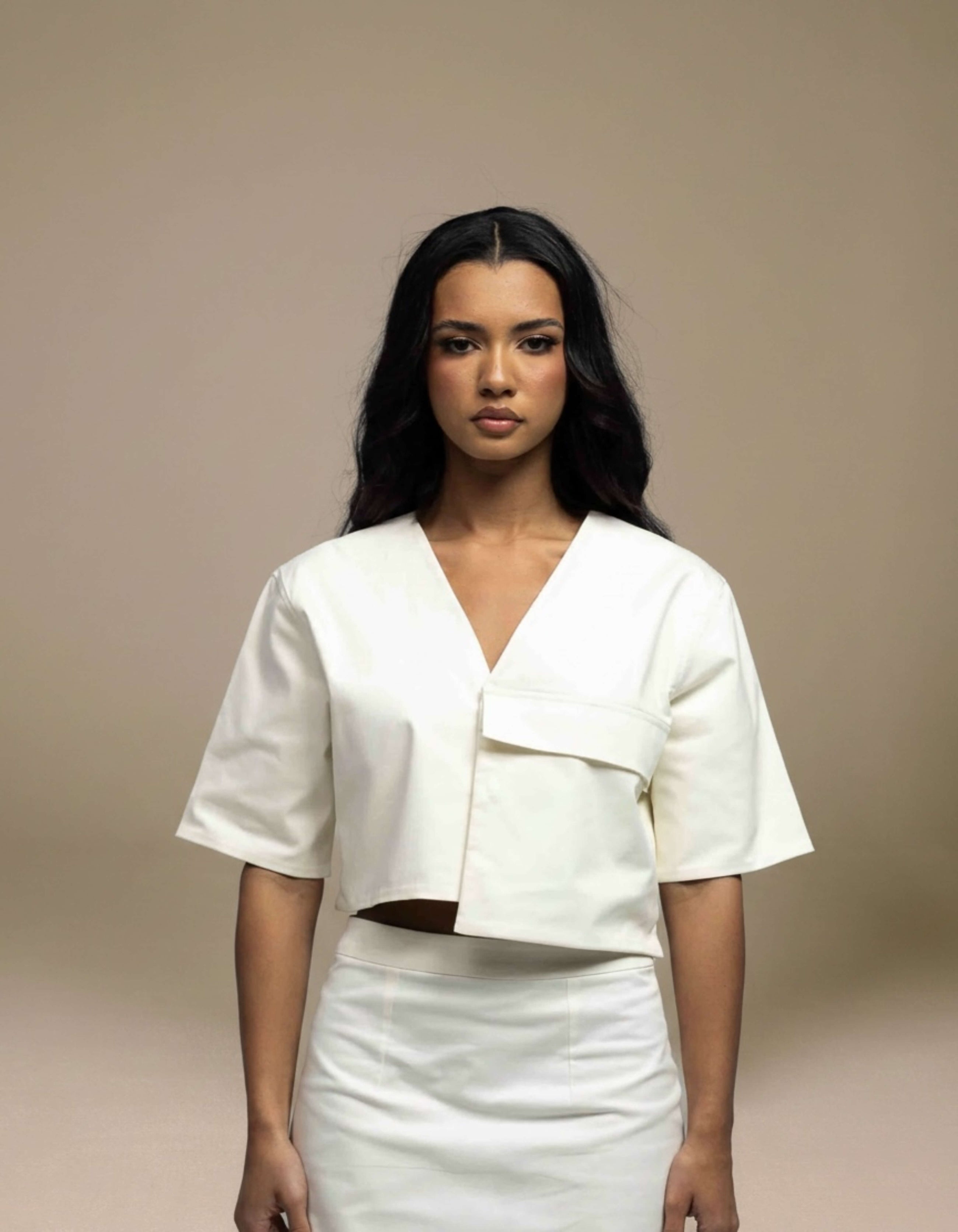 Ivory structured crop top with asymmetric hem and V-neckline, luxury womenswear

