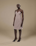 Blush minimalist slip dress with V-neckline and spaghetti straps, knee-length luxury womenswear
