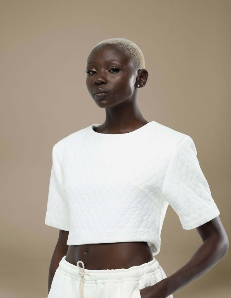 White quilted cropped top with short sleeves, minimalist luxury womenswear
