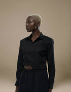 Black cropped tailored shirt with open collar, minimalist luxury womenswear
