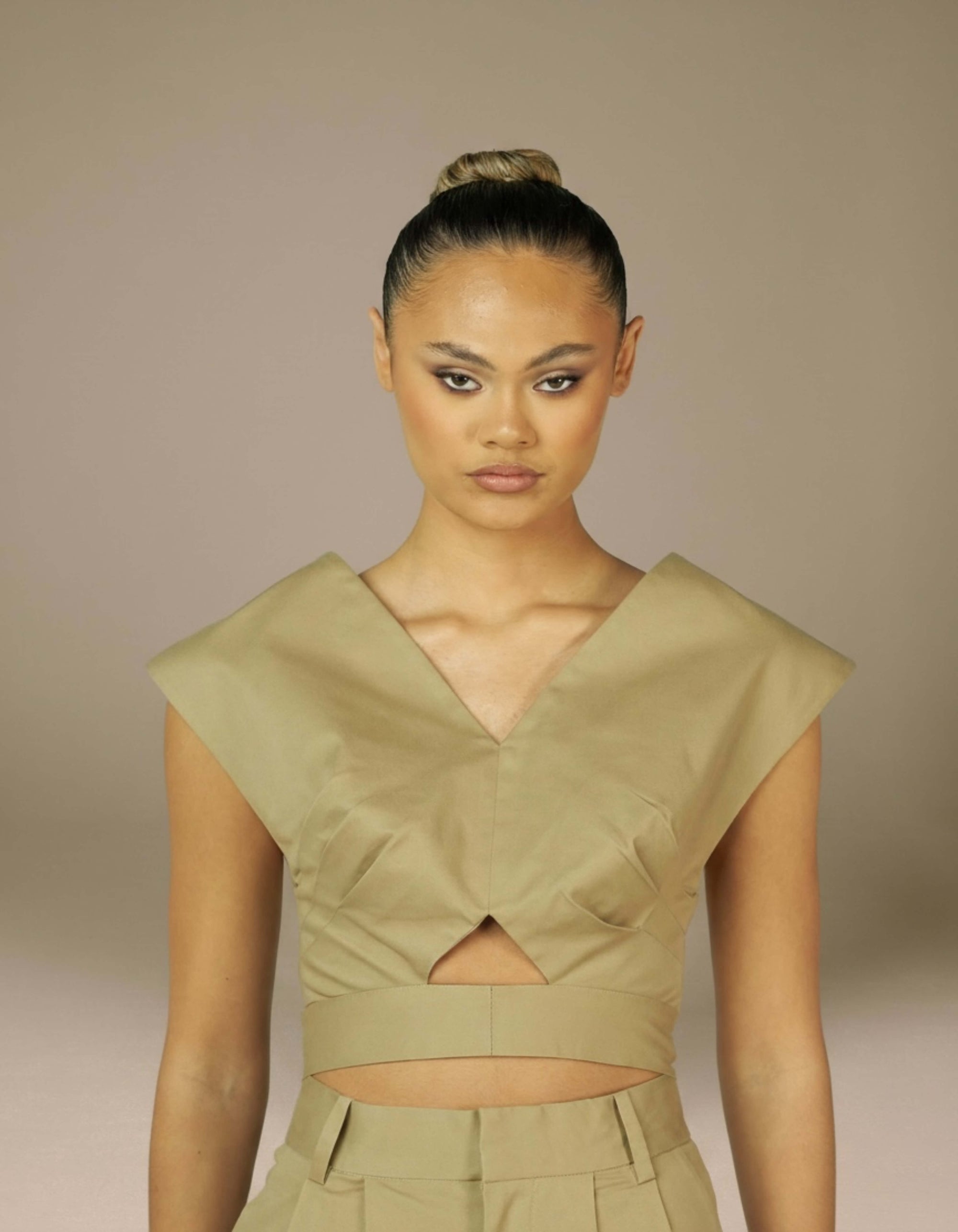 Structured khaki crop top with deep V-neck sculptural shoulders luxury womenswear
