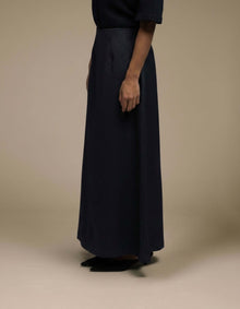 Navy A-line maxi skirt minimalist luxury womenswear side profile

