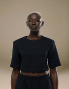 Black quilted textured crop top with structured short sleeves, luxury womenswear
