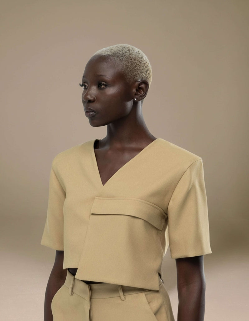 Tailored sand cropped top with structured waistband and V-neckline
