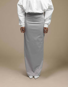 Minimalist silver-grey maxi skirt styled with white tailored shirt
