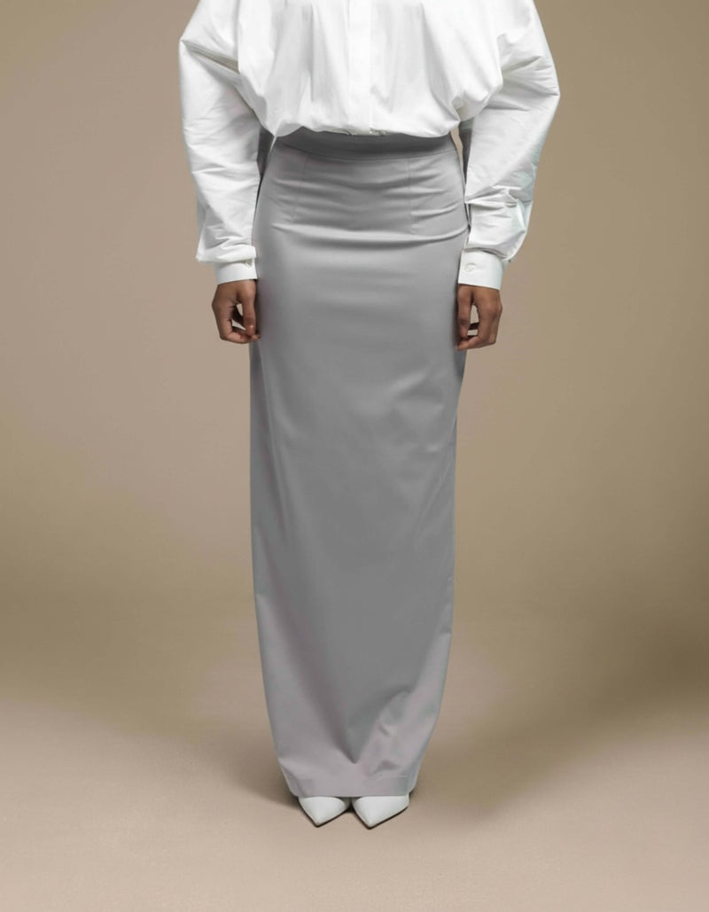 Minimalist silver-grey maxi skirt styled with white tailored shirt
