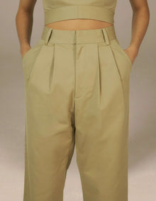 Sage green high-waist pleated tailored trousers luxury womenswear
