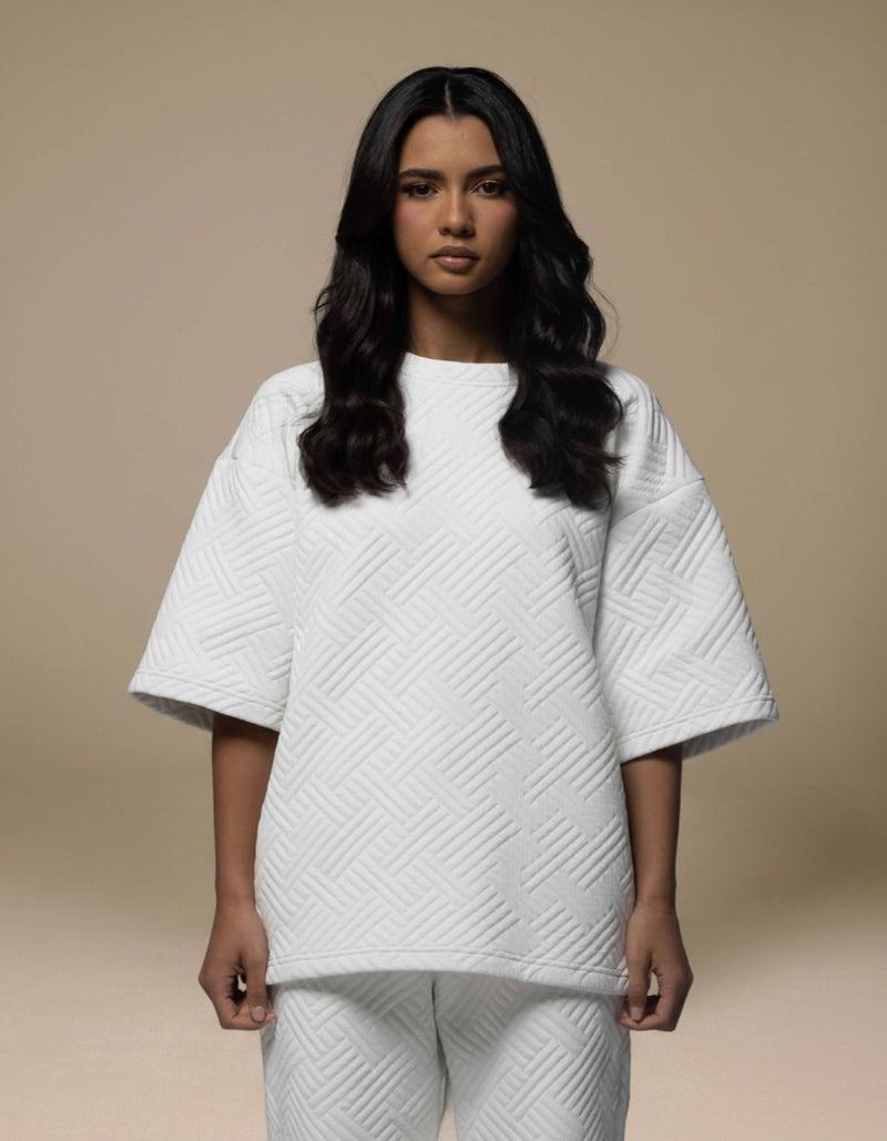 White quilted oversized top with geometric texture, luxury womenswear co-ord set
