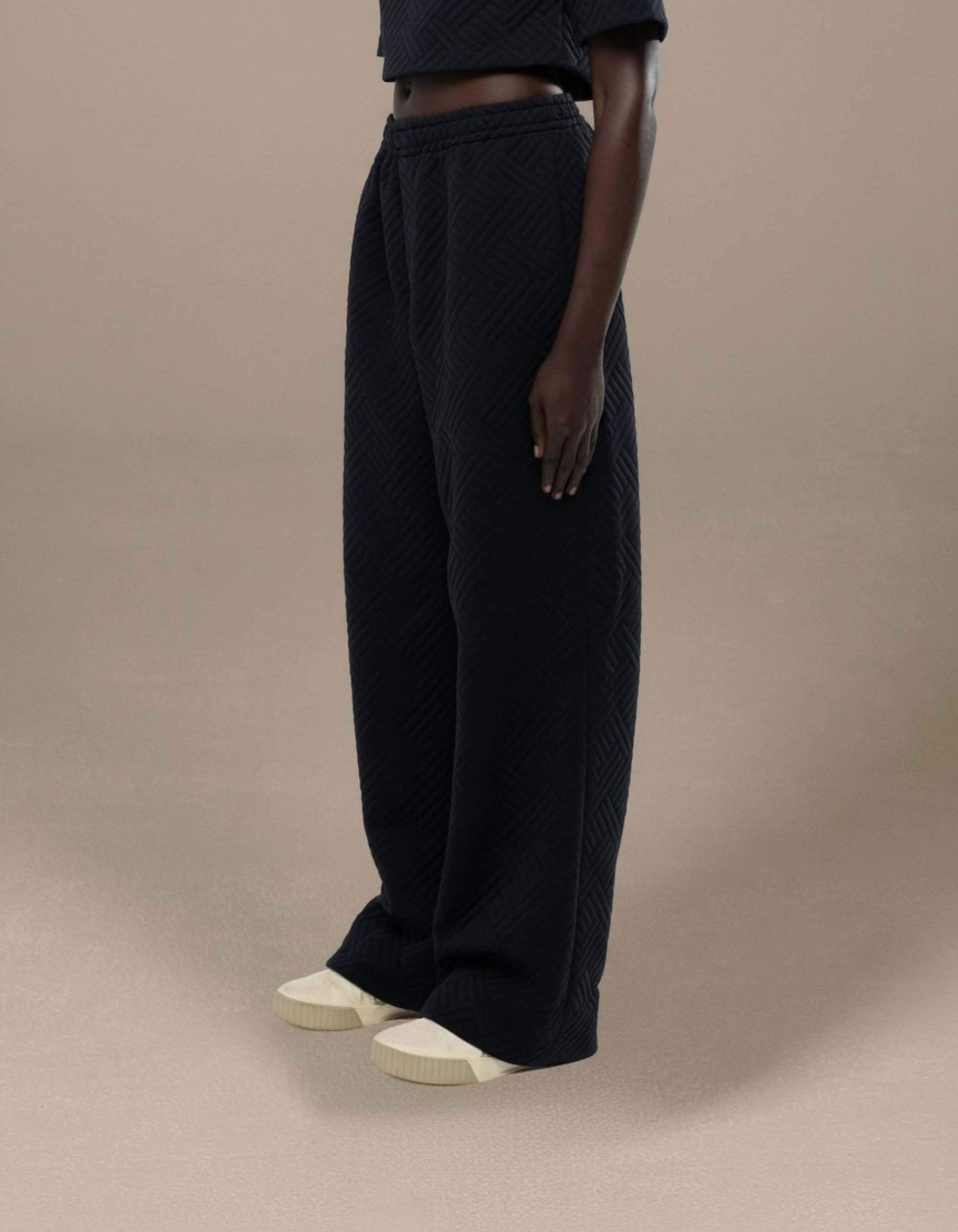 Black quilted wide-leg trousers with geometric texture, luxury womenswear
