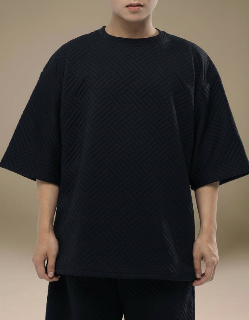 Black oversized quilted geometric top minimalist luxury womenswear
