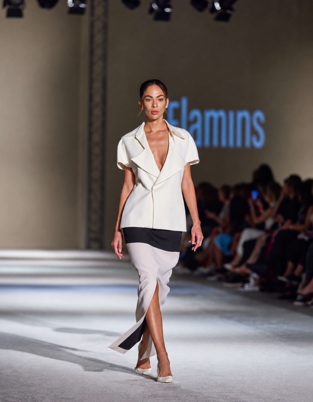 Elamins Exaggerated Lapel Top In Off White paired with horizontal two tone structured skirt On The Runway At TheEventDXB