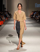 Full-Length Runway View Of The Elamins Vertical Two Tone Skirt In Tan And Denim Paired With The Elamins Oversize Pocket Crop Top At TheEventDXB Fashion Show.